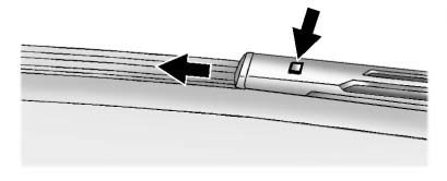 Chevrolet Equinox: Vehicle Checks. 2. Press the square button on the top side, at the end of the wiper arm, and